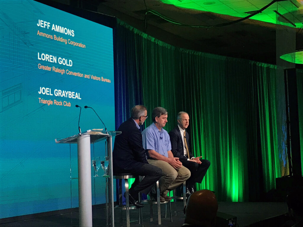 Three panelists sitting on chairs